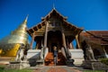 Young woman traveler traveling to Wat Phra Singh temple. This te