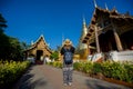 Young woman traveler traveling to Wat Phra Singh temple. This te Royalty Free Stock Photo