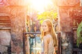 Young woman traveler in Ubud palace, Bali - Inside the Ubud palace, Bali, Indonesia with sunlight Royalty Free Stock Photo