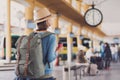 Young woman traveler waiting for a bus on a bus station, travel and active lifestyle concept Royalty Free Stock Photo