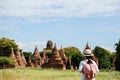 Young woman traveling backpacker with hat, Asian traveler looking Beautiful ancient temples and pagoda, landmark and popular for Royalty Free Stock Photo