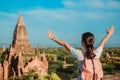 Woman traveling backpacker with hat, Asian traveler standing on Pagoda and looking Beautiful ancient temples, landmark and popular Royalty Free Stock Photo