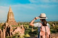 Young woman traveling backpacker with hat, Asian traveler standing on Pagoda and looking Beautiful ancient temples Royalty Free Stock Photo