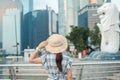 Young Woman traveling with hat in the morning, happy Asian traveler visit in Singapore city downtown. landmark and popular for