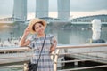 Young Woman traveling with hat in the morning, happy Asian traveler visit in Singapore city downtown. landmark and popular for