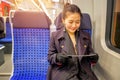 Young woman traveling looking ticket while sitting in the train