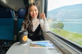 Young woman traveling looking view while sitting in the train