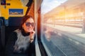 Young woman traveling looking view while sitting in the train