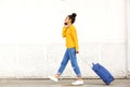 Young woman traveling with suitcase and mobile phone Royalty Free Stock Photo