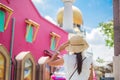 Young woman traveling with white dress and hat, happy Asian traveler looking to Masjid Sultan, Singapore Mosque. landmark and