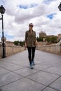 Young woman traveller walking through a bridge during a antumn afternoon