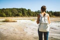 Young woman trekking to the Solfatara di Manziana sulphurous area in Italy.