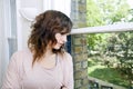 Young woman in trendy office looking out the window Royalty Free Stock Photo