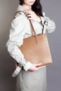 Young woman in trendy trench coat and bag