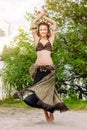 Young woman tribal american style dancer. Girl dancing and posing on the beach sand wearing belly dance costume. Ethnic Royalty Free Stock Photo