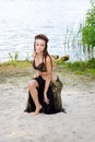 Young woman tribal american style dancer. Girl dancing and posing on the beach sand wearing belly dance costume. Ethnic Royalty Free Stock Photo