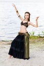 Young woman tribal american style dancer. Girl dancing and posing on the beach sand wearing belly dance costume. Ethnic Royalty Free Stock Photo