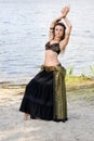 Young woman tribal american style dancer. Girl dancing and posing on the beach sand wearing belly dance costume. Ethnic Royalty Free Stock Photo