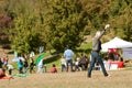 Young Woman Tries To Get Kite Airborne At Public Festival