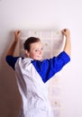 Young woman tries on wall-papers Royalty Free Stock Photo