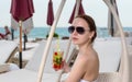 Young Woman with Tropical Drink on Resort Patio Royalty Free Stock Photo