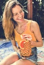 Young woman with a tropical pineapple
