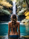 young woman at tropical waterfall water falling into blue lake tourist enjoying the relaxing view exotic travel destination