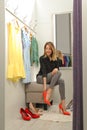 Young woman trying on shoes in dressing room Royalty Free Stock Photo