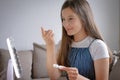 Young woman trying to apply contact lenses in front of mirror. Young girl trying on new contact lenses. Close up of girl trying on