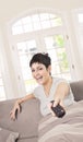 Young woman with TV remote Royalty Free Stock Photo