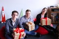 Young woman and two man posing and smiling with holiday boxes wi Royalty Free Stock Photo