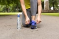 Young woman tying laces of running shoes before training. Healthy lifestyle concept Royalty Free Stock Photo