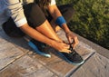 Young woman tying shoelace of sneakers to make outwork training running. Fitness and healthy lifestyle Royalty Free Stock Photo