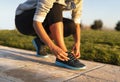 Young woman tying shoelace of sneakers to make outwork training running. Fitness and healthy lifestyle Royalty Free Stock Photo