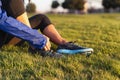 Young woman tying shoelace of sneakers to make outwork training running. Fitness and healthy lifestyle Royalty Free Stock Photo