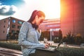 Young woman typing on laptop at outdoor Royalty Free Stock Photo