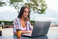 Young woman typing on a laptop studying or working in the park Royalty Free Stock Photo