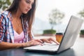 Young woman typing on a laptop studying or working in the park Royalty Free Stock Photo