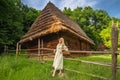 Young woman in ukrainian national costume near old house Royalty Free Stock Photo