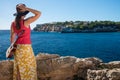 Woman with ukulele standing at the coast of Mallorca island