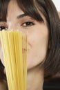 Young Woman With Uncooked Spaghetti