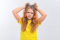 Young woman is under huge mental pressure. Portrait of freaked out shocked teen girl pulling out hair and shouting from regret,