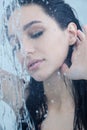 Young woman under shower with water drops Royalty Free Stock Photo