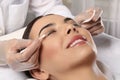 Young woman undergoing eyelash lamination in salon, closeup