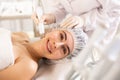 Young woman undergoing radiofrequency facial skin tightening procedure Royalty Free Stock Photo