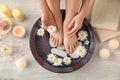 Young woman undergoing spa pedicure treatment in beauty salon