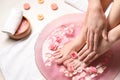 Young woman undergoing spa pedicure treatment in beauty salon