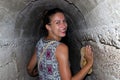 Young woman in underground passage of 7 Springs, Rhodes, Greece