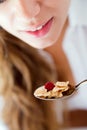 Young woman in underwear eating cereals. Isolated on white. Royalty Free Stock Photo