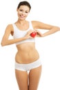 Young woman in underwear holding a heart model